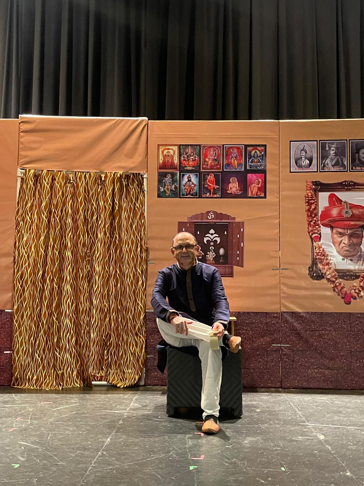 Abhay Dharmadhikari seated on a theatre set